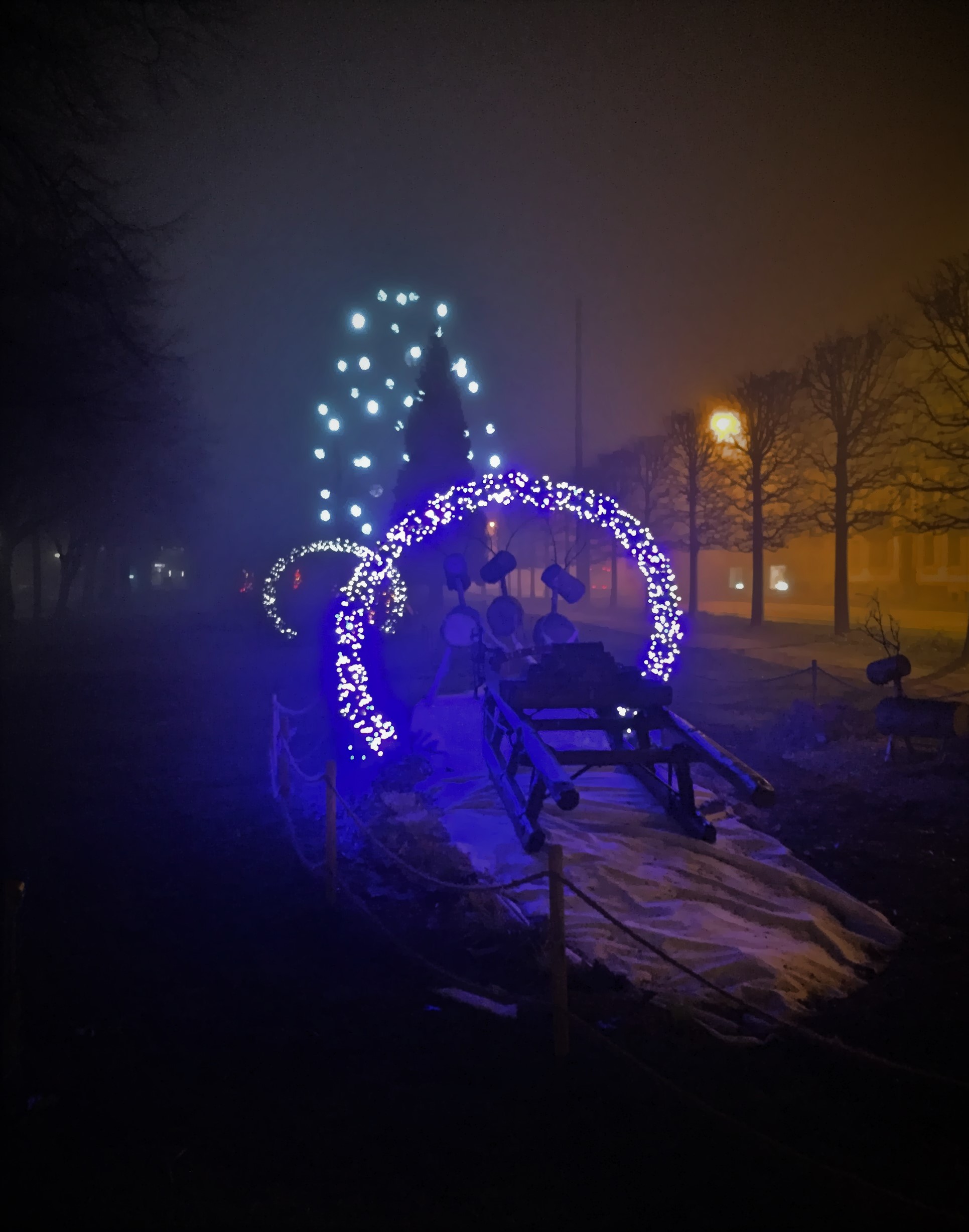 image of wooden reindeer Christmas decoration illuminated in a park